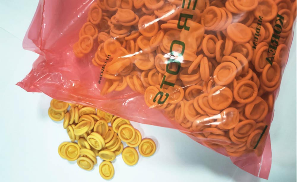 Doigtiers industriels jetables en latex jaune orange antidérapants